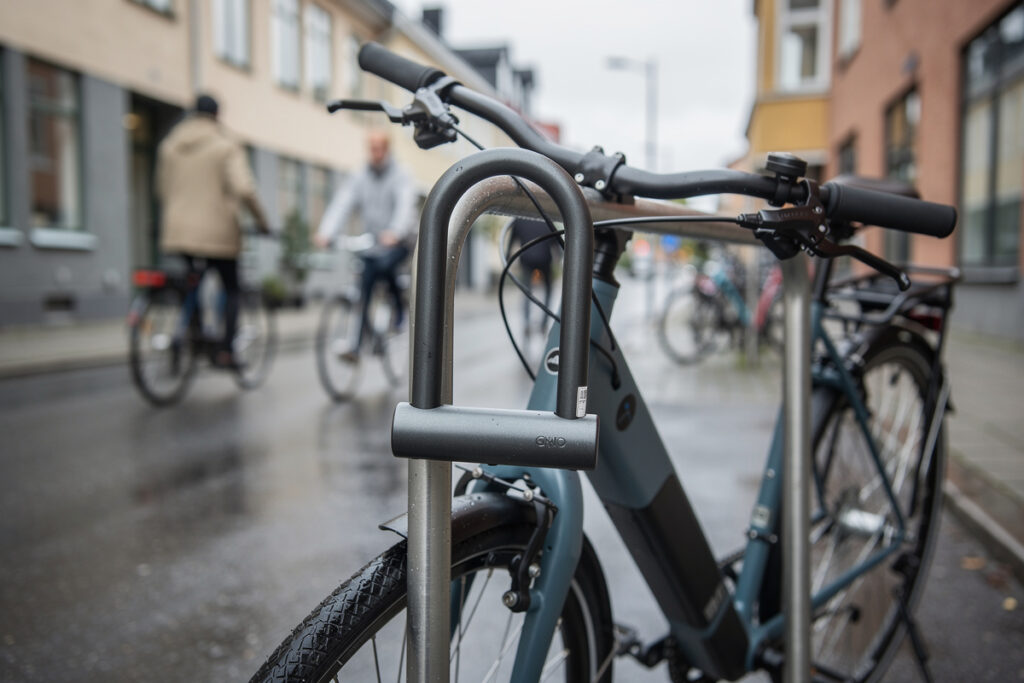 Hardened steel U-lock securing an e-bike to a bike rack