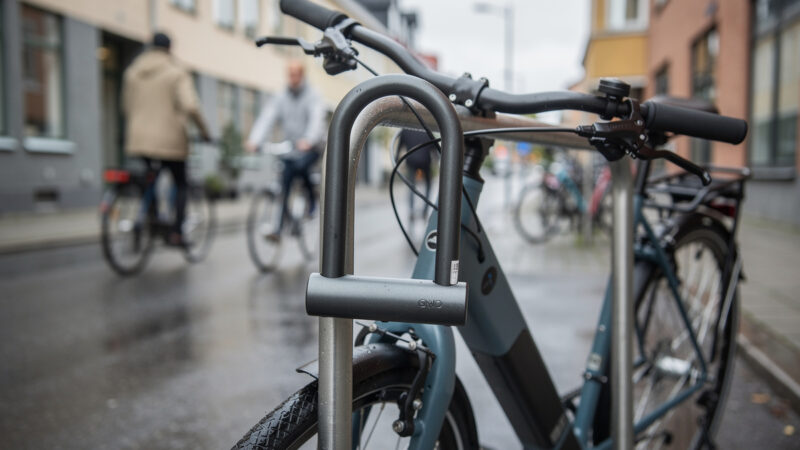 Hardened steel U-lock securing an e-bike to a bike rack