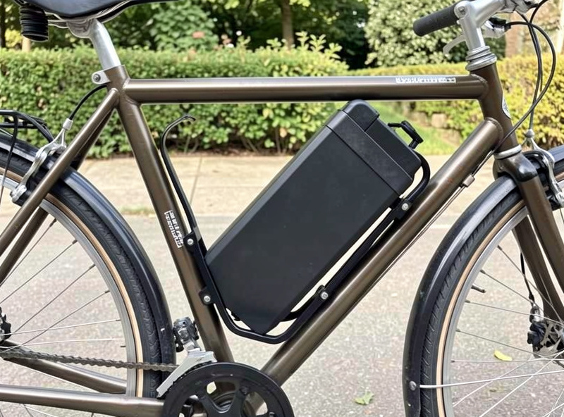 Down-tube e-bike battery pack mounted to a converted bicycle frame with the mounting cradle visible