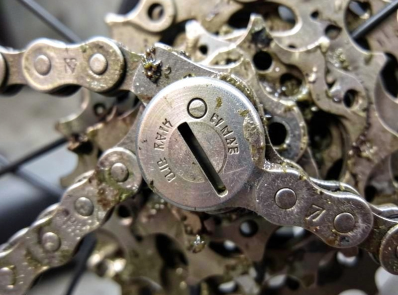 Chain wear gauge seated on a worn e-bike chain and cassette