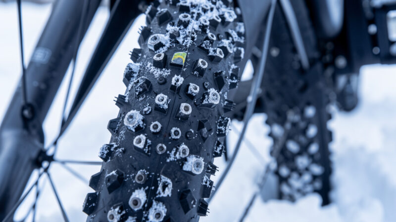 Studded winter e-bike tire with carbide studs against snow